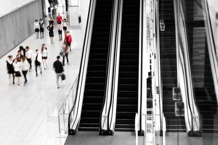 People rushing on escalator in business center, mall or airport to work,  with motion blur .のeditorial素材
