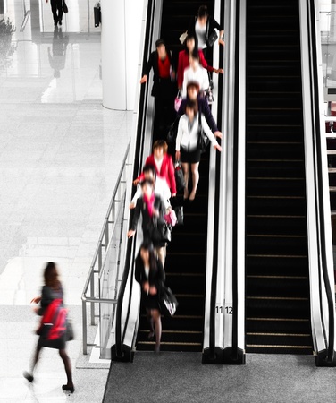 People rushing on escalator in business center, mall or airport to work,  with motion blur .
のeditorial素材