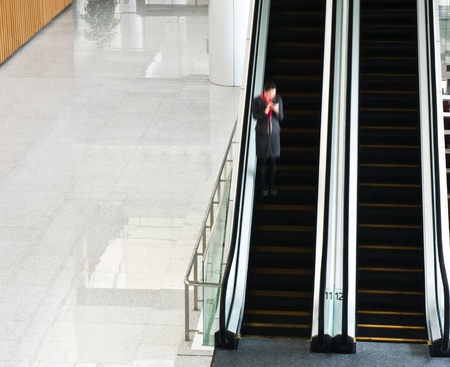 People rushing on escalator in business center, mall or airport to work,  with motion blur .
のeditorial素材