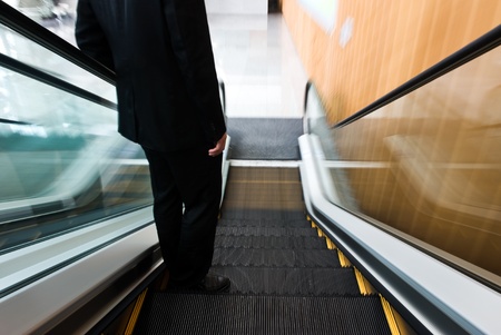 businessman going down the escalator.Motion blur 
のeditorial素材