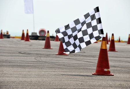 checkered race flag standing on floor.の写真素材