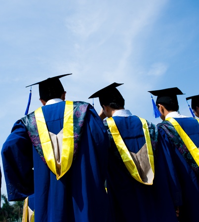 back of chinese graduates with blue sky の写真素材