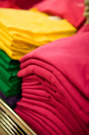 Colorful pile of T-shirts in a shop.