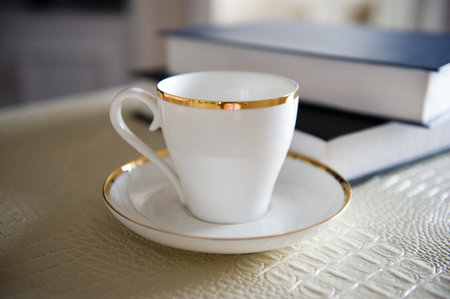 Coffee cup and book on the board. の写真素材