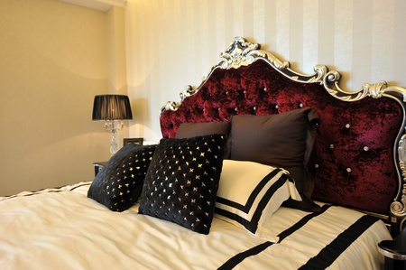 Bedroom with lamp king-size bed and many pillows.の写真素材