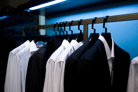 Row of men's suits hanging in closet.の写真素材
