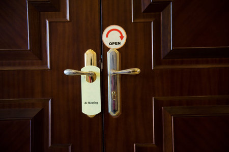 Meeting sign hanging from hotel door handle.