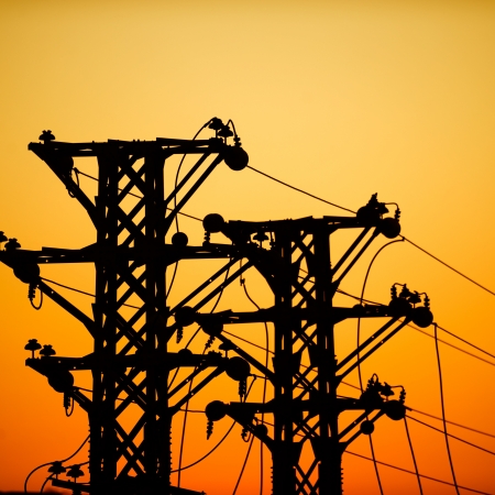 high voltage post at sunset.の写真素材