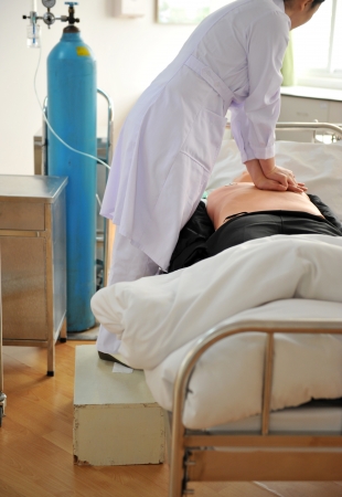 The man on a dummy trains to do cardiopulmonary resuscitation.の写真素材