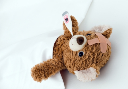 Teddy bear ill in bedの写真素材