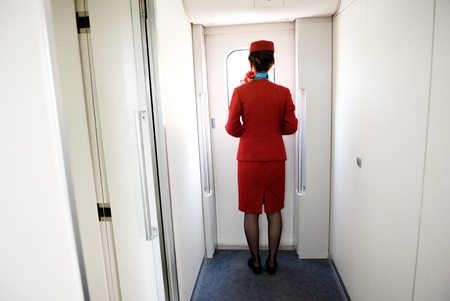 waitress with red uniforms on railway, China.の写真素材