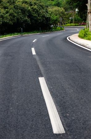 Asphalt road winding through the forest.の写真素材