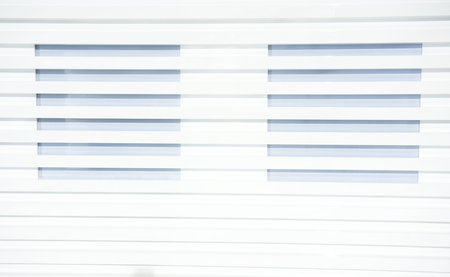 white painted of wooden wall with two windows.