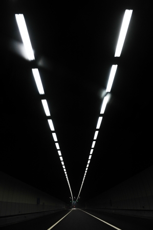 long tunnel with lights overhead.のeditorial素材