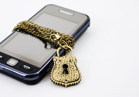 Blocked mobile phone with a chain and lock isolated