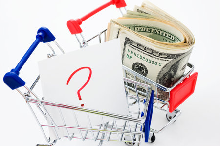 Shopping cart and stocks of dollars close up shot,  looking for solution or answers