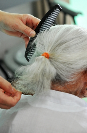 young people comb for an old lady.の写真素材