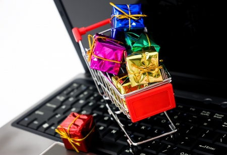 Shopping cart with gift box on the keyboard of computer,  for christmas theme. の写真素材