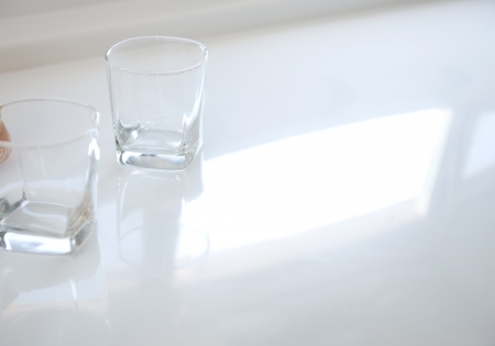 Two glasses on a reflective table top の写真素材