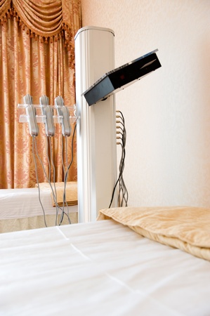 bed in a beauty saloon, with machines for treatments.の写真素材