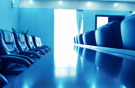 Head office boardroom with leather chairs, blue tone.の写真素材