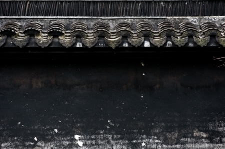 A black asian wall background with white eaves and grunge stains.の写真素材