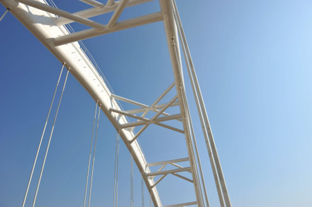 Abstract view of bridge support against a blue sky.