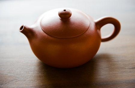Red clay Chinese tea pot on wooden tableの写真素材