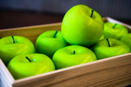 many green apples in a wooden container の写真素材