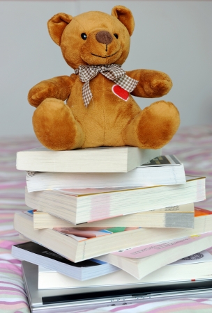 teddy bear and pile of booksの写真素材