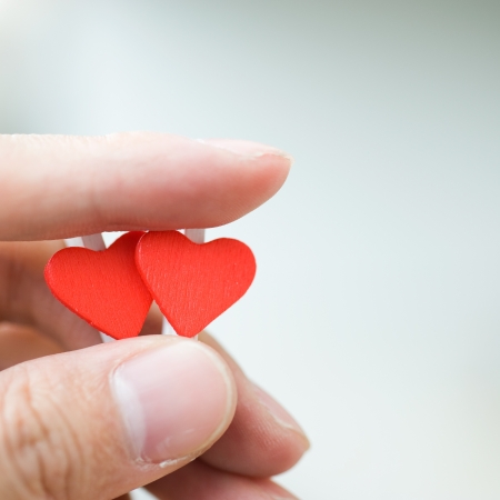 love concept. holding a red heart in hands. の写真素材