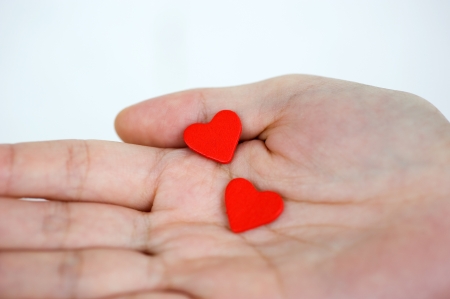 love concept. holding a red heart in hands. の写真素材