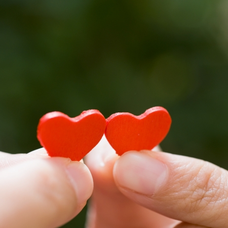 love concept. holding a red heart in hands. の写真素材