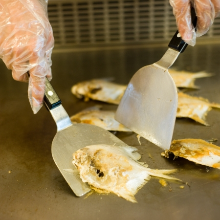 Japanese chef cooking traditional butterfish teppanyaki on a hot plate. の写真素材