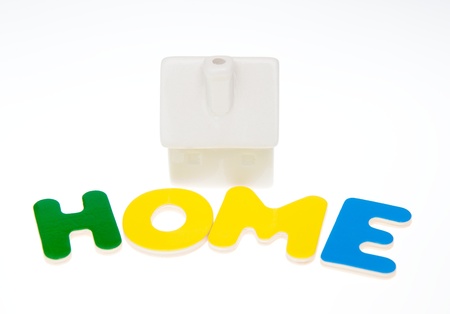 Small house with word HOME isolated on white background の写真素材