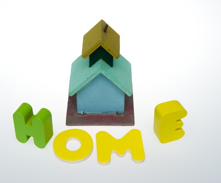 Small house with word HOME isolated on white background の写真素材