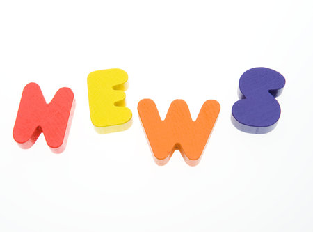 Wooden letters spelling the word  " news "  on white background.の写真素材