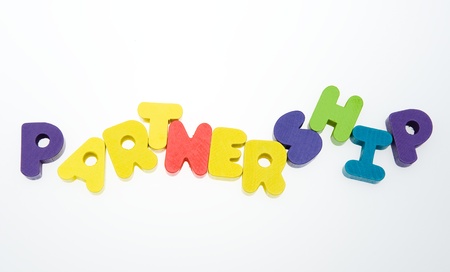 Wooden letters spelling the word  " partnership "  on white background. の写真素材