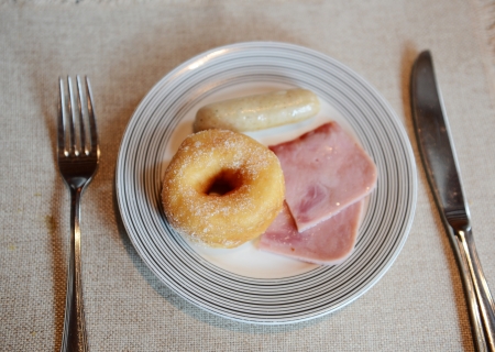 Breakfast with bread, meat, and sausage.の写真素材