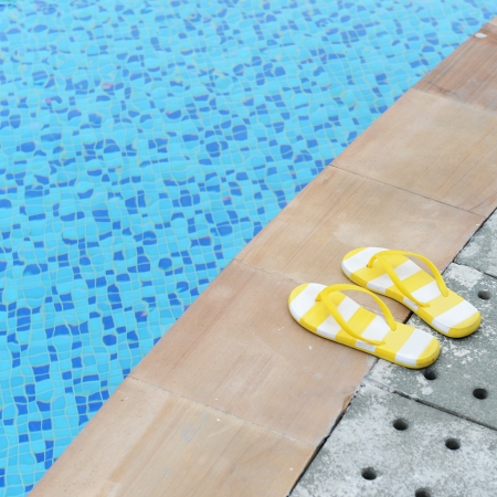 women's sandals  by a swimming pool の写真素材