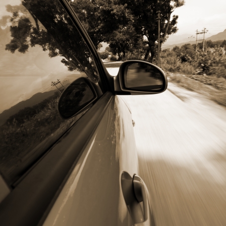 car driving fast into forest の写真素材