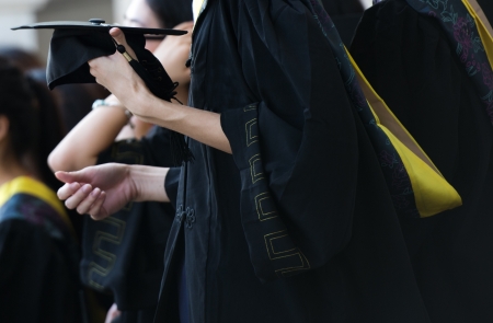 graduating student holding their mortarboard in hand. の写真素材