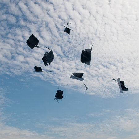 Mortarboards  in the air at graduation.の写真素材