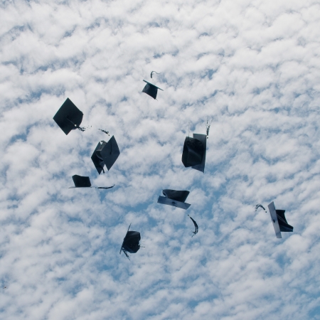 Mortarboards  in the air at graduation.の写真素材