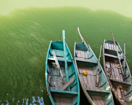 Three old fishing boats floating on the water.の写真素材
