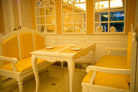 Empty cafe with a table and chairs near the window.のeditorial素材