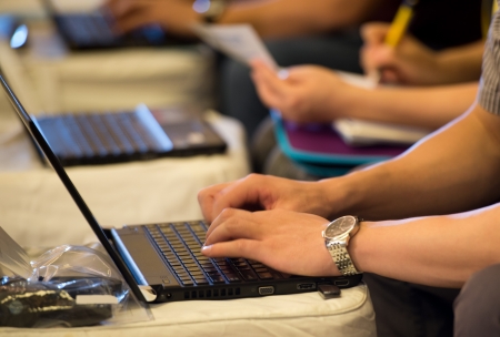 Human hands typing on laptop keyboard.の写真素材