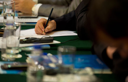 Closeup of human hand writing on a paper.