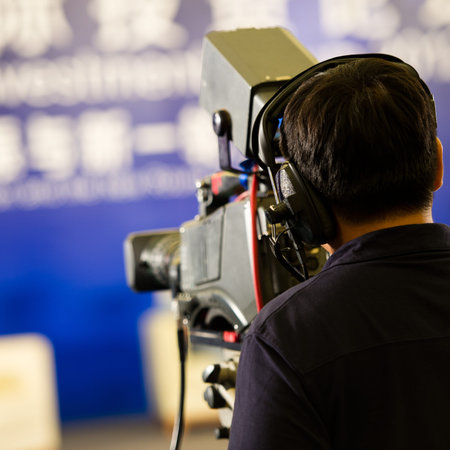 journalist in a row with video camera for tv reportage.