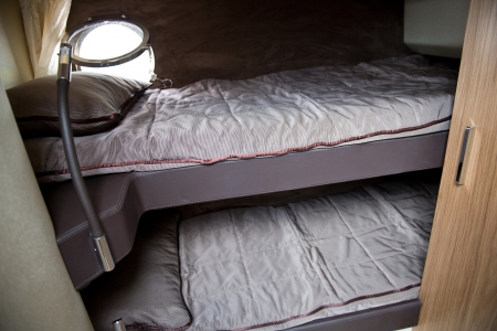 interior of a luxury yacht - with beds and window.の写真素材